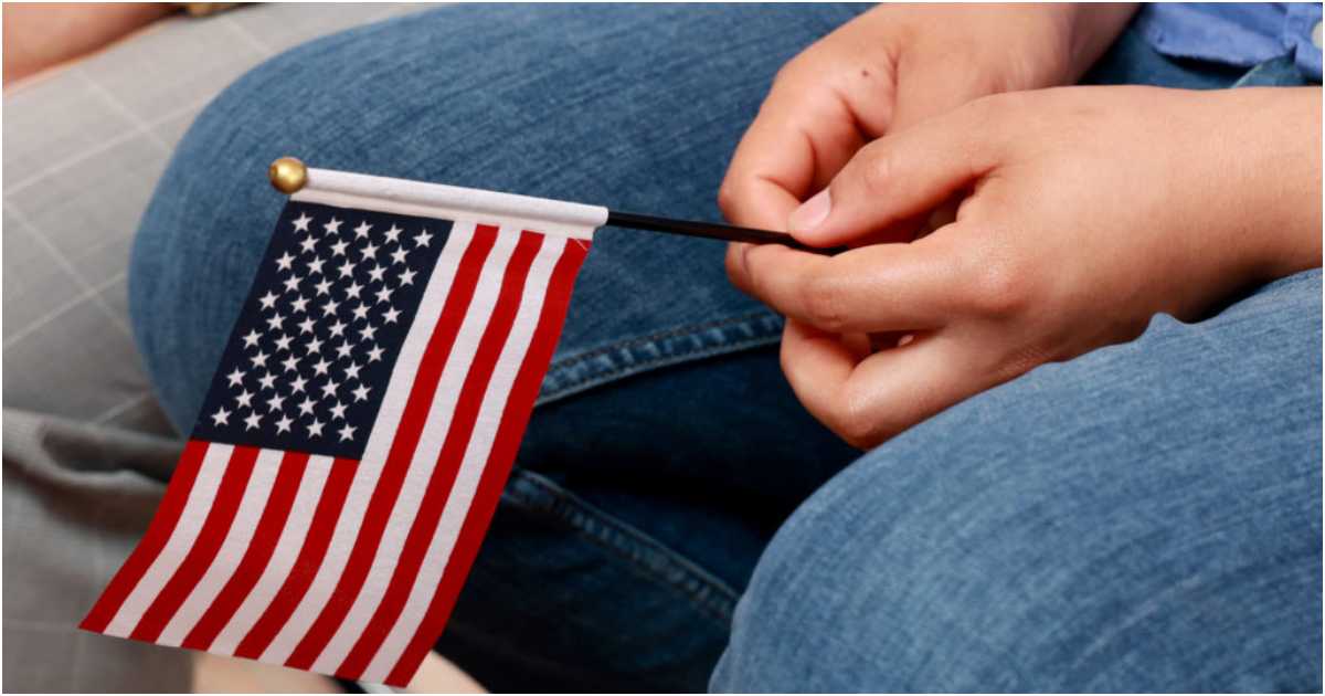 অ্যামেরিকার পতাকা হাতে এক ব্যক্তি। ছবি: পিবিএস